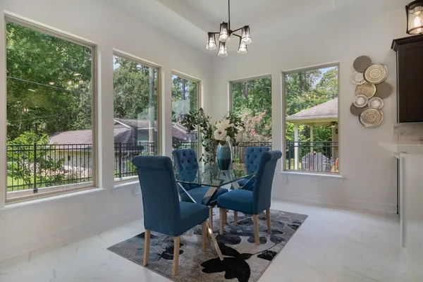 a view of a dining room with furniture window and outside view