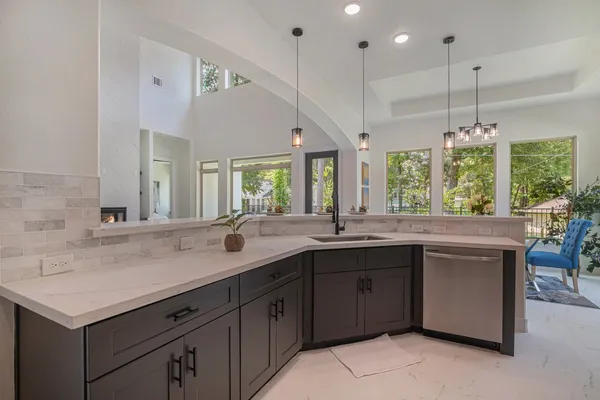 a kitchen with a stove a sink and a window