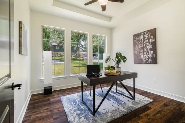 a living room with furniture and wooden floor