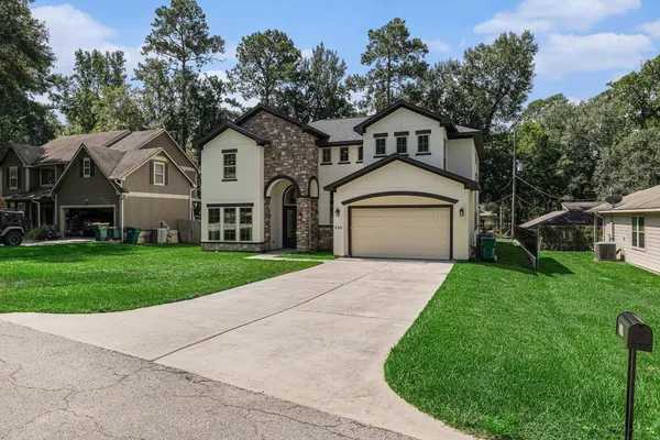a front view of a house with a yard and garage
