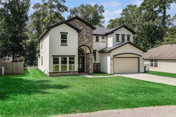a front view of a house with a yard and garage