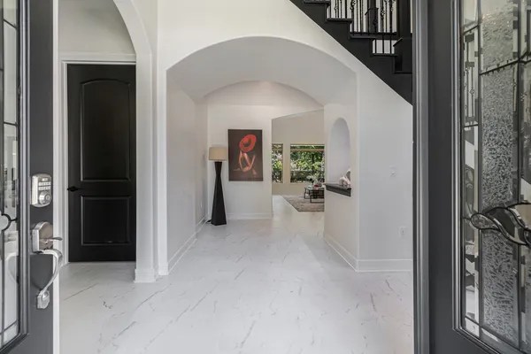 a bed room with a bed and a painting on the wall