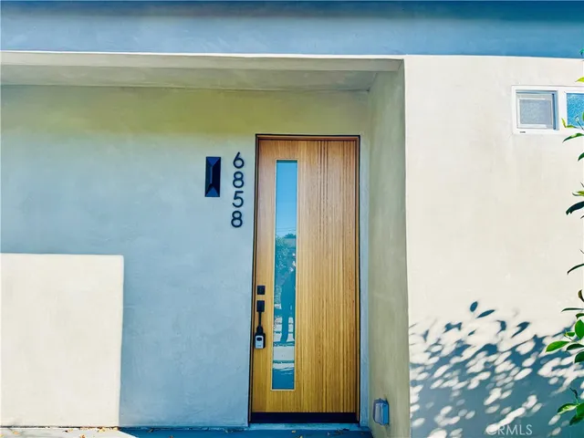 a view of a back yard with flower plants