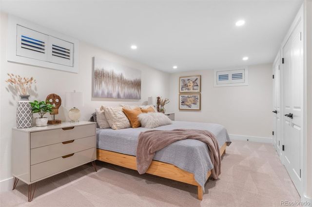 a spacious bedroom with a bed and a couch