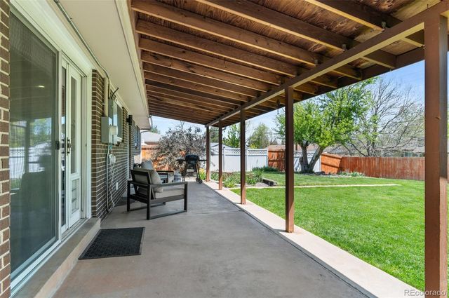 a view of a porch with furniture and garden