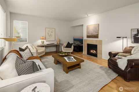 a living room with furniture fireplace and a window