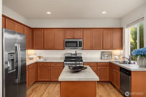 a kitchen with a sink stove and refrigerator