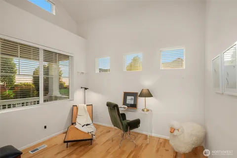 a view of a workspace with furniture and a window