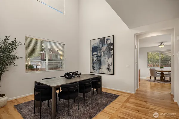 a dining room with furniture and wooden floor