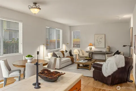 a living room with furniture chess table and a window