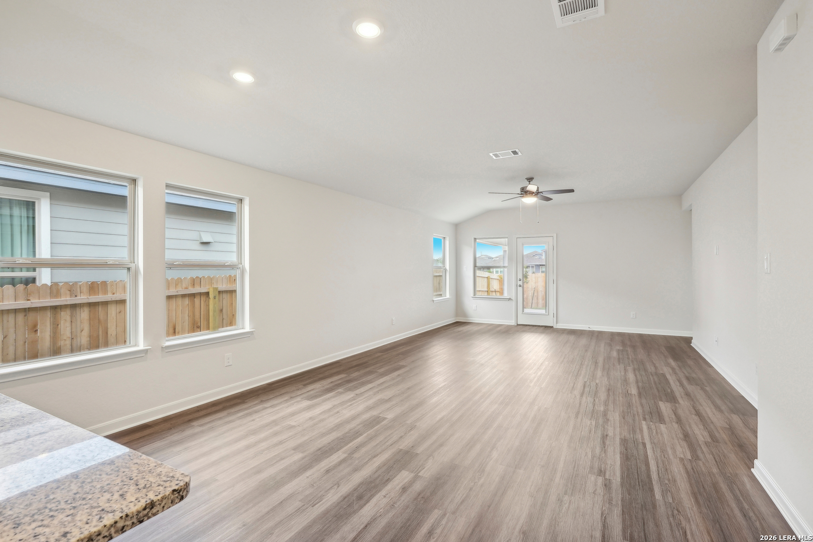 2902 Clemente Way Converse, TX 78109 - Photo 4 of 37 a view of an empty room with wooden floor and a window