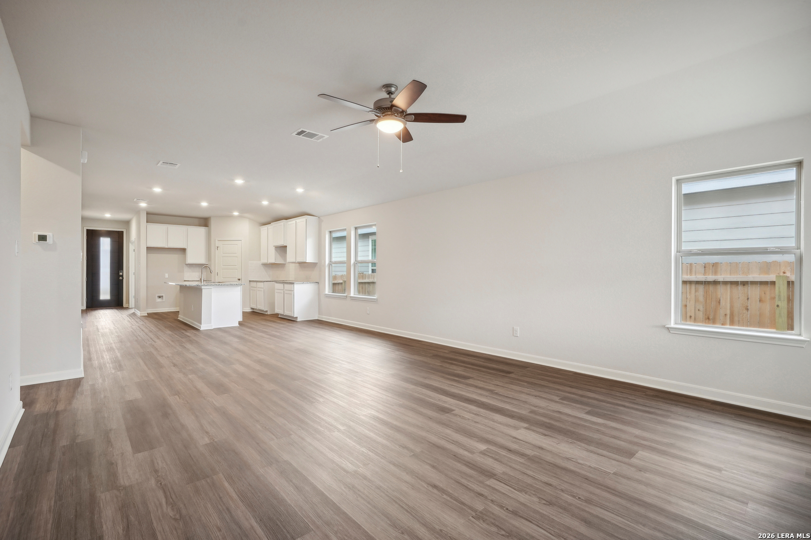 2902 Clemente Way Converse, TX 78109 - Photo 7 of 37 a view of an empty room with wooden floor and a window