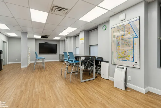 a hallway with a table and chairs