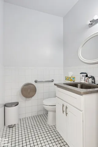 a living room with furniture a rug and a book shelf