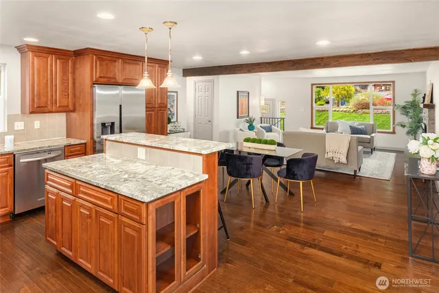 a kitchen with stainless steel appliances granite countertop a sink stove and refrigerator