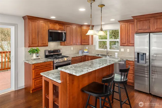 a kitchen with granite countertop a sink and a window