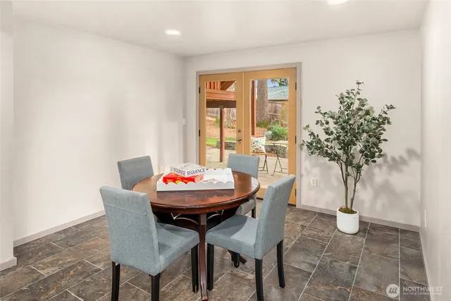 a balcony with wooden floor and trees in the back