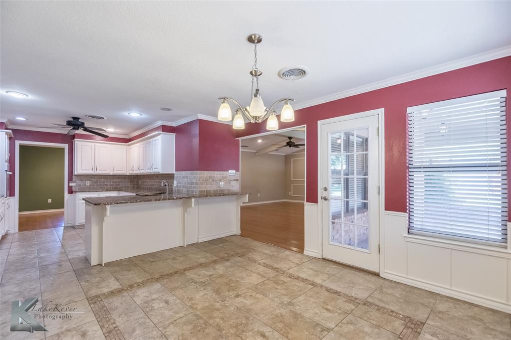 42 Riviera Circle Abilene, TX 79606 - Photo 12 of 39 a kitchen with a refrigerator a sink dishwasher with a dining table and chairs