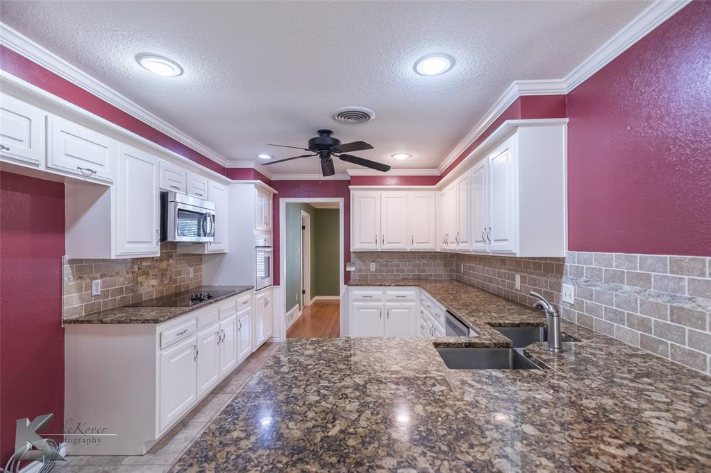42 Riviera Circle Abilene, TX 79606 - Photo 13 of 39 a kitchen with granite countertop a sink and a stove