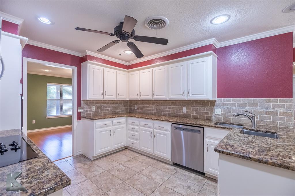 42 Riviera Circle Abilene, TX 79606 - Photo 15 of 39 a kitchen with granite countertop a sink and cabinets