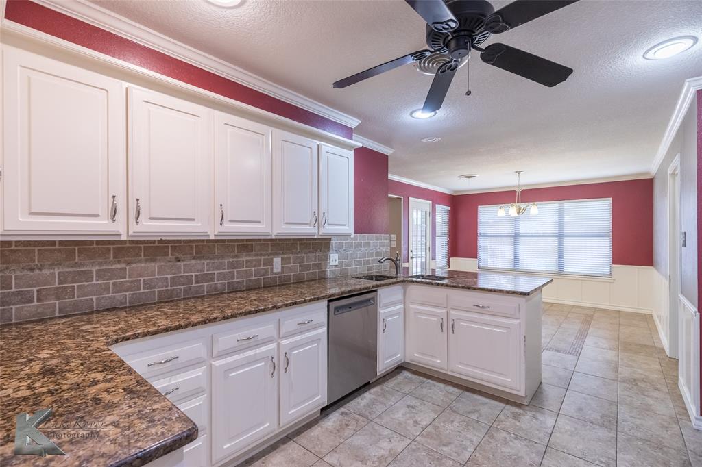 42 Riviera Circle Abilene, TX 79606 - Photo 16 of 39 a kitchen with a sink window and cabinets