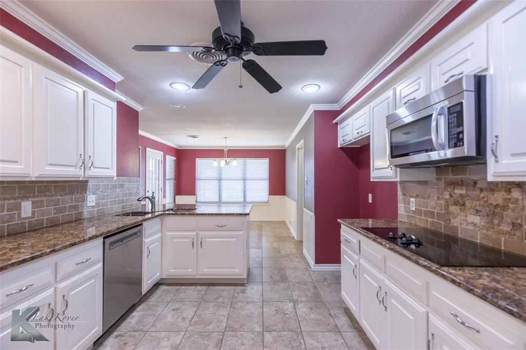 42 Riviera Circle Abilene, TX 79606 - Photo 17 of 39 a large kitchen with stainless steel appliances granite countertop a sink and cabinets
