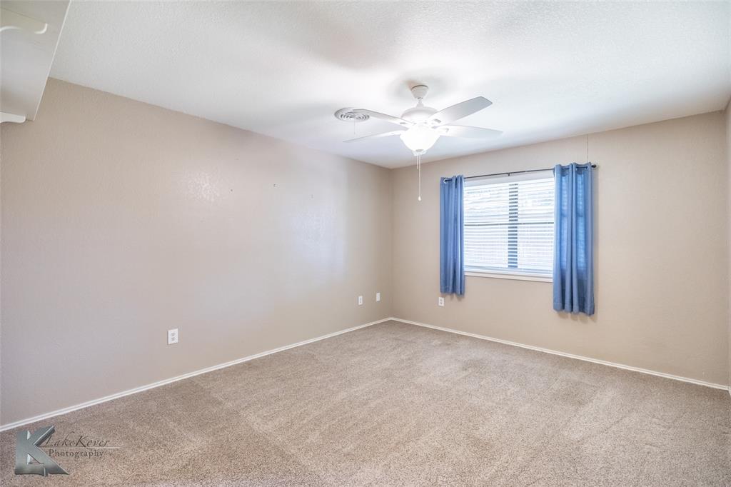 42 Riviera Circle Abilene, TX 79606 - Photo 18 of 39 an empty room with windows and fan