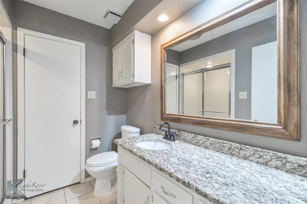 42 Riviera Circle Abilene, TX 79606 - Photo 20 of 39 a bathroom with a granite countertop sink toilet and mirror