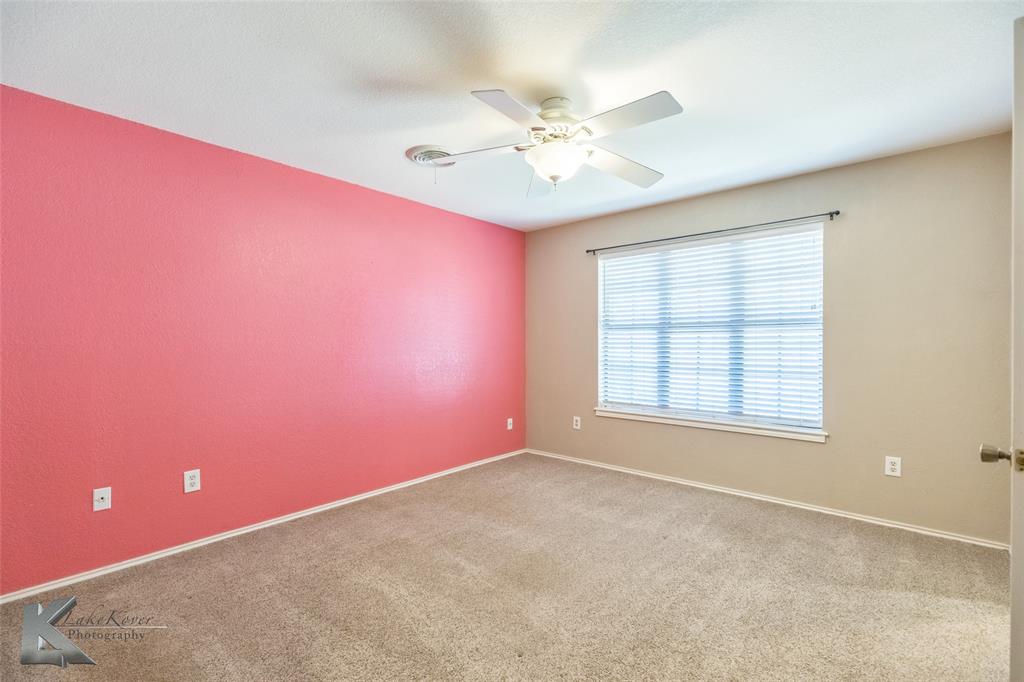 42 Riviera Circle Abilene, TX 79606 - Photo 23 of 39 an empty room with chandelier fan and windows