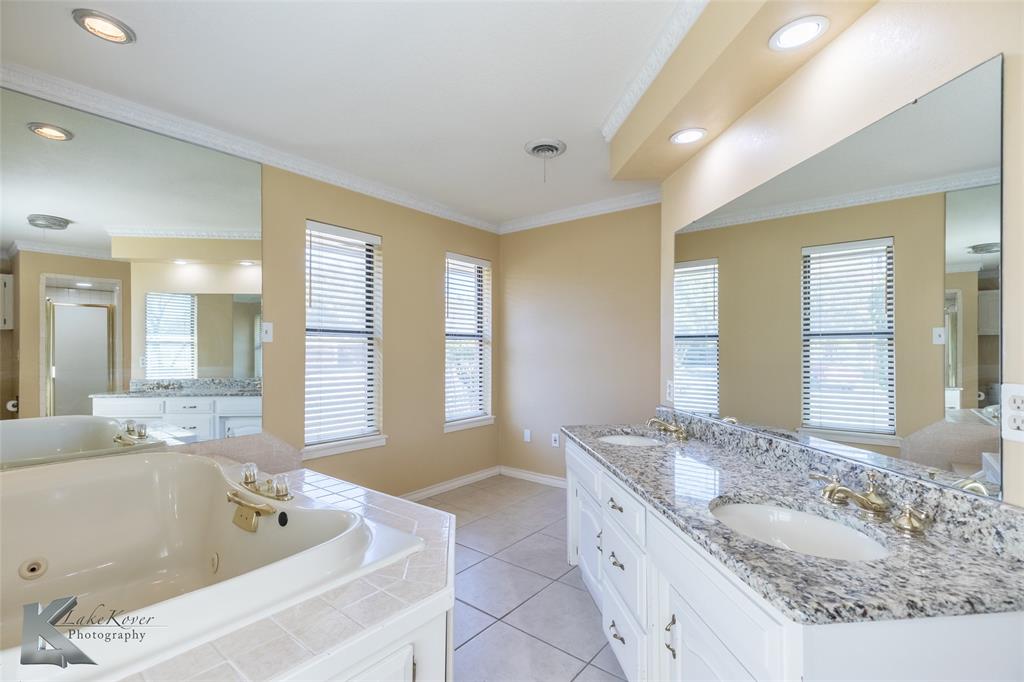 42 Riviera Circle Abilene, TX 79606 - Photo 29 of 39 a bathroom with a granite countertop tub sink and mirror