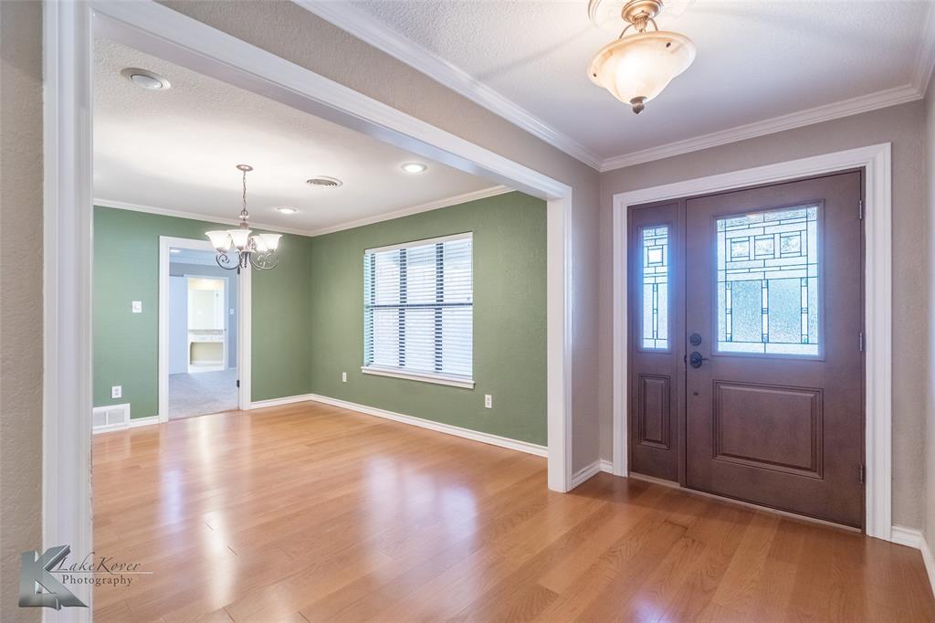 42 Riviera Circle Abilene, TX 79606 - Photo 4 of 39 a view of an empty room with a window and wooden floor