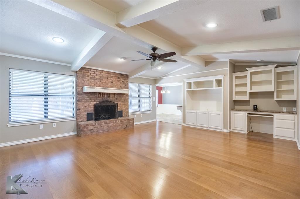42 Riviera Circle Abilene, TX 79606 - Photo 6 of 39 an empty room with wooden floor fire place and windows