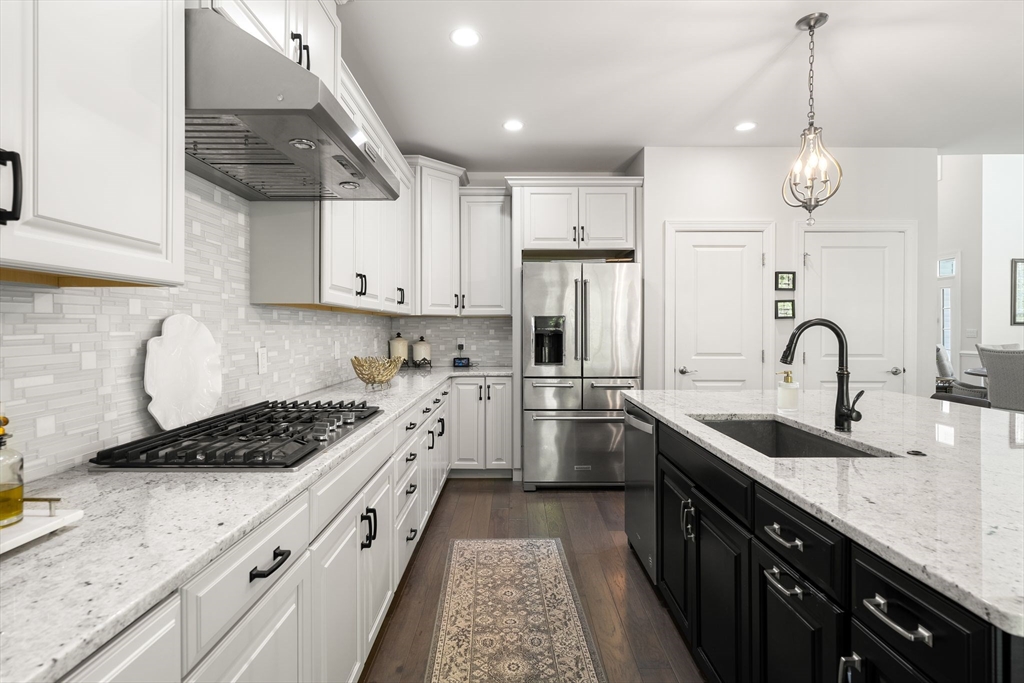 2 Hummingbird Way, Unit 1 Methuen, MA 01844 - Photo 12 of 42 a kitchen with stainless steel appliances a sink a stove a refrigerator and cabinets