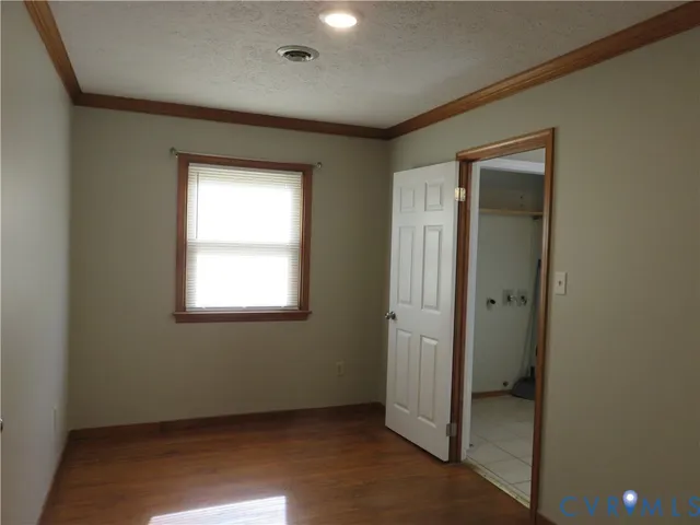 an empty room with windows and closet