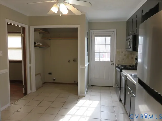 a kitchen with a refrigerator a stove top oven and cabinets