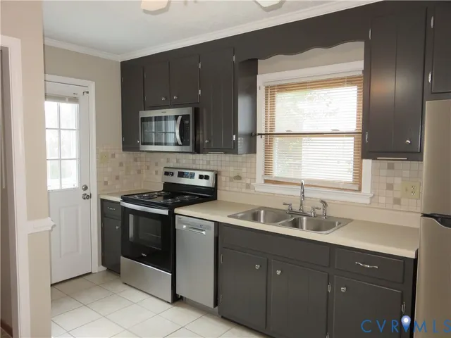 a kitchen with a stove sink and microwave
