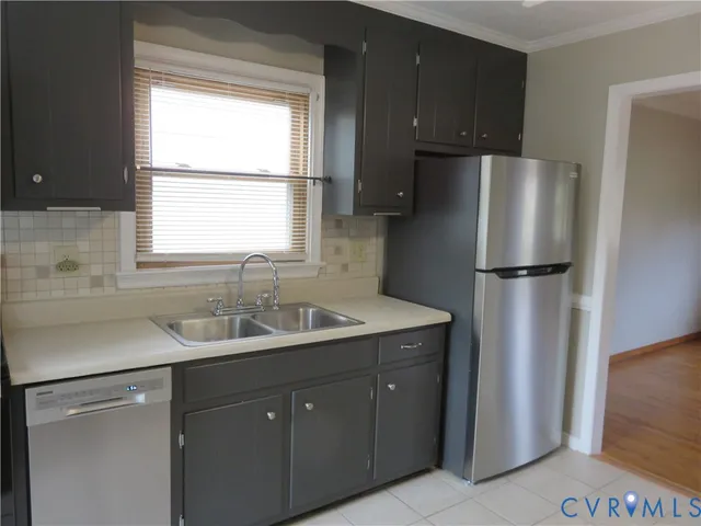 a kitchen with a refrigerator and a sink