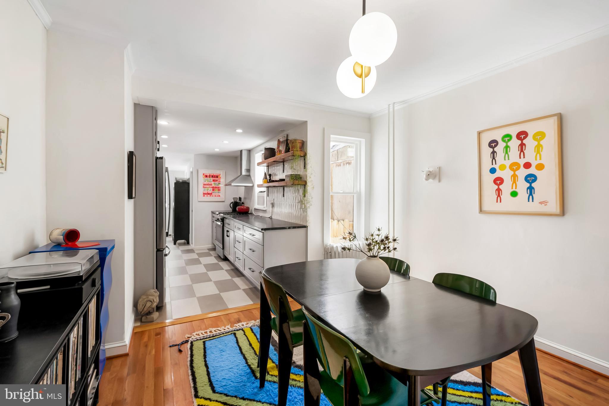 3409 Keswick Road Baltimore, MD 21211 - Photo 12 of 49 a view of a dining room with furniture and wooden floor