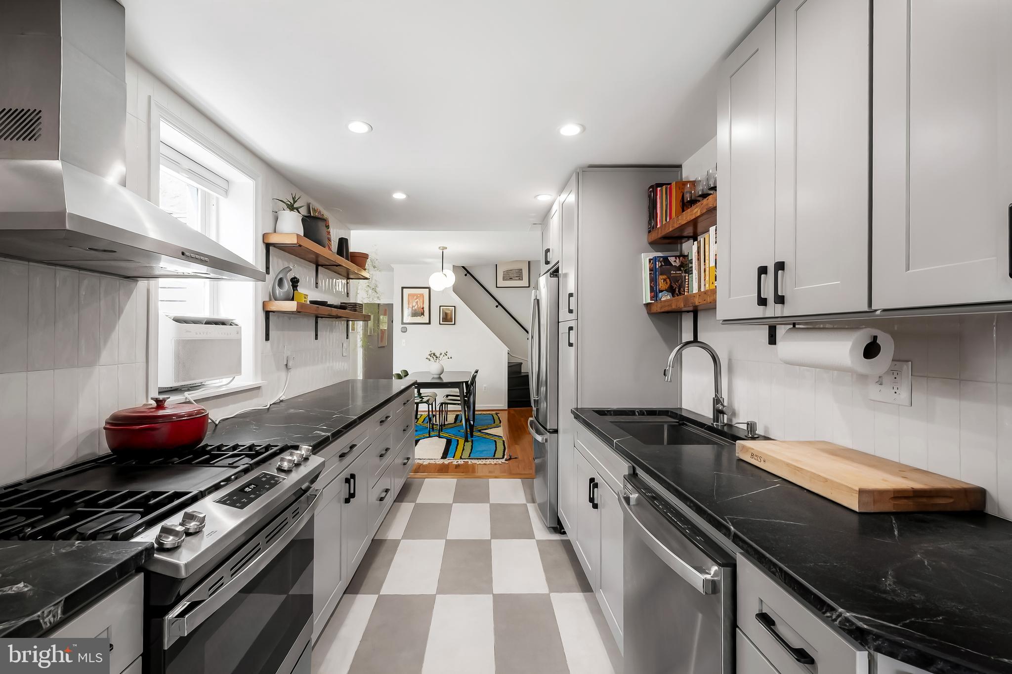 3409 Keswick Road Baltimore, MD 21211 - Photo 14 of 49 a kitchen with stainless steel appliances granite countertop a sink and cabinets
