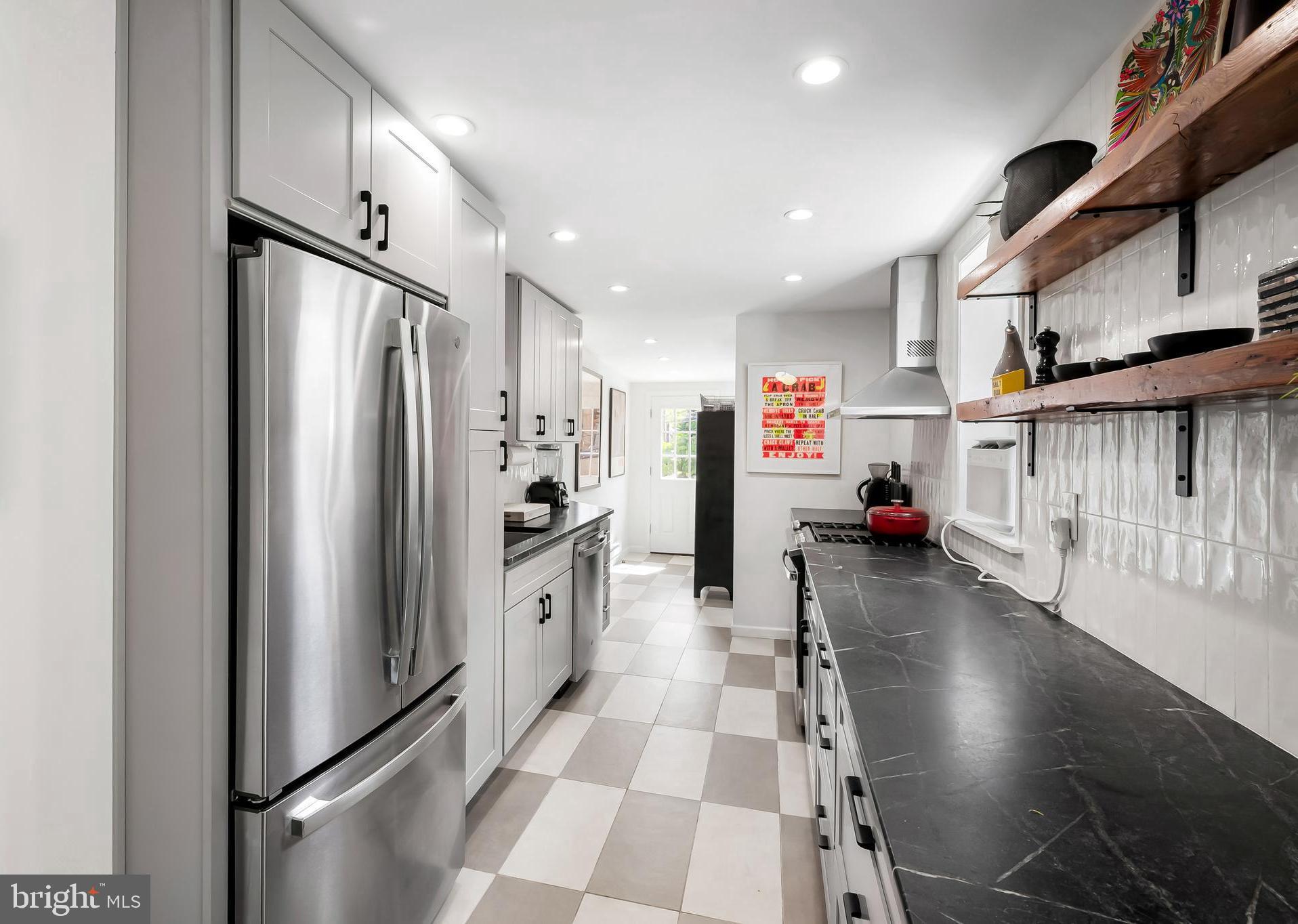 3409 Keswick Road Baltimore, MD 21211 - Photo 17 of 49 a kitchen with stainless steel appliances granite countertop a refrigerator and a sink