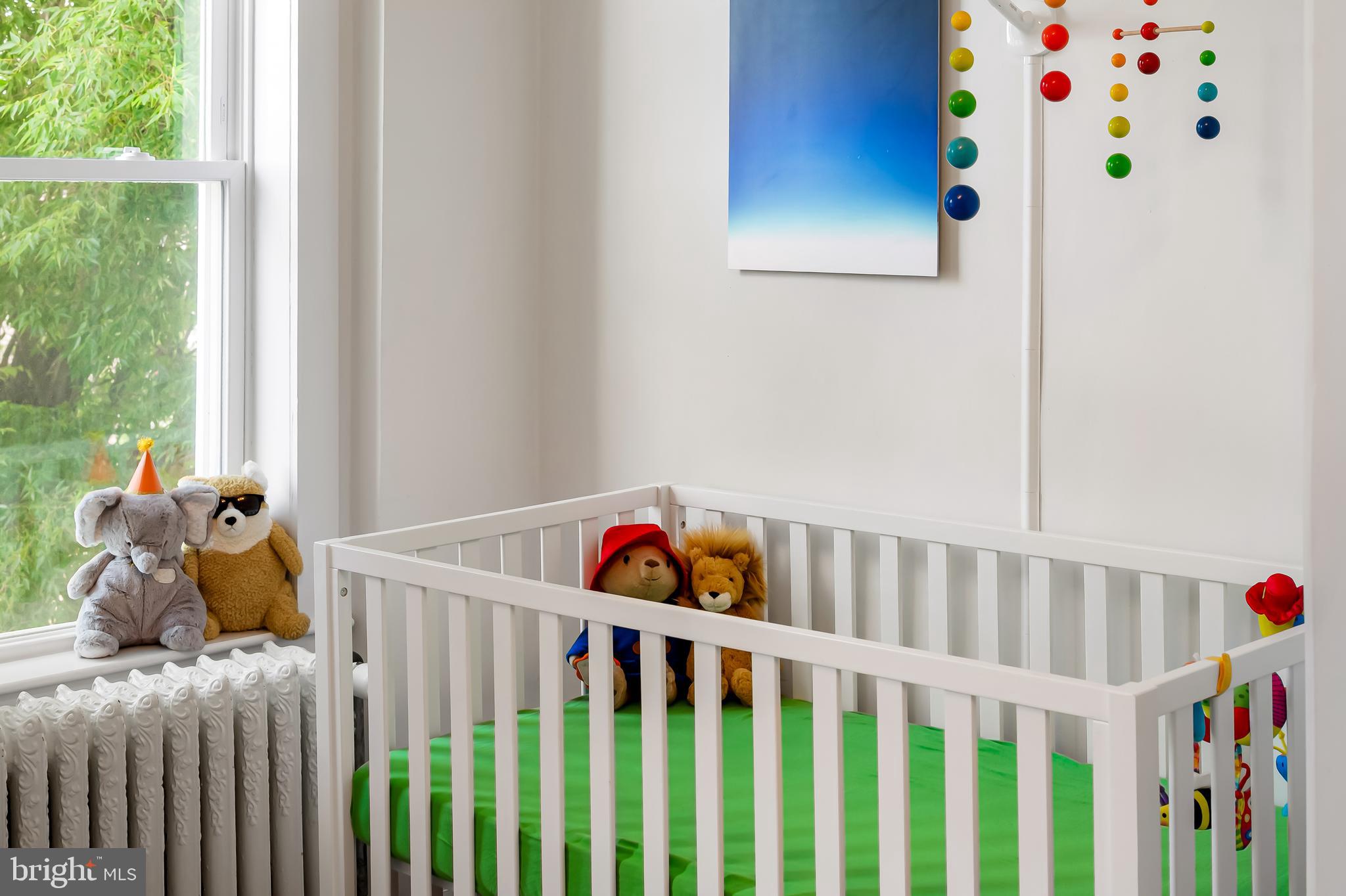 3409 Keswick Road Baltimore, MD 21211 - Photo 23 of 49 a bedroom with baby crib and wooden floor