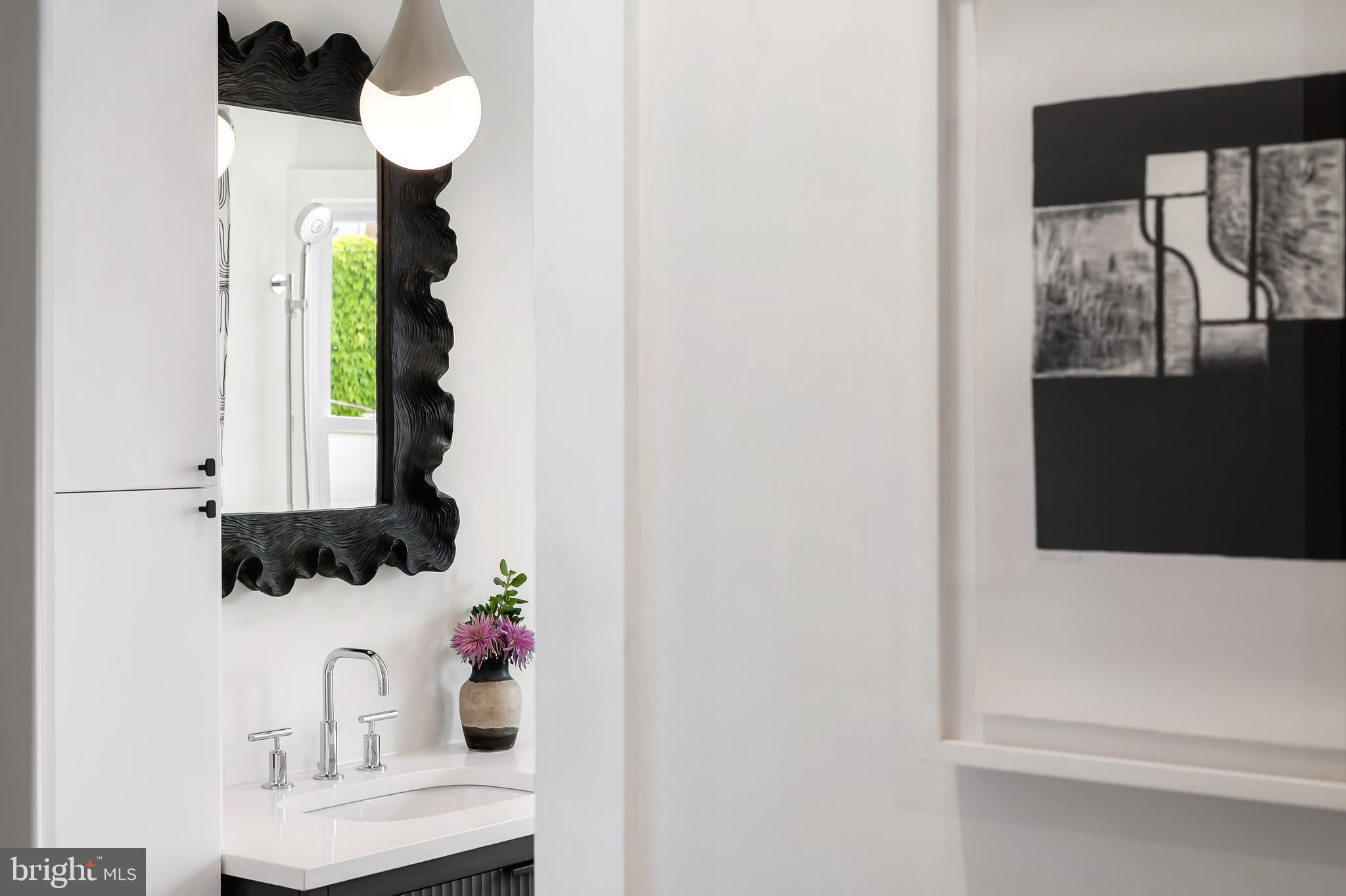 3409 Keswick Road Baltimore, MD 21211 - Photo 27 of 49 a bathroom with a sink and a mirror