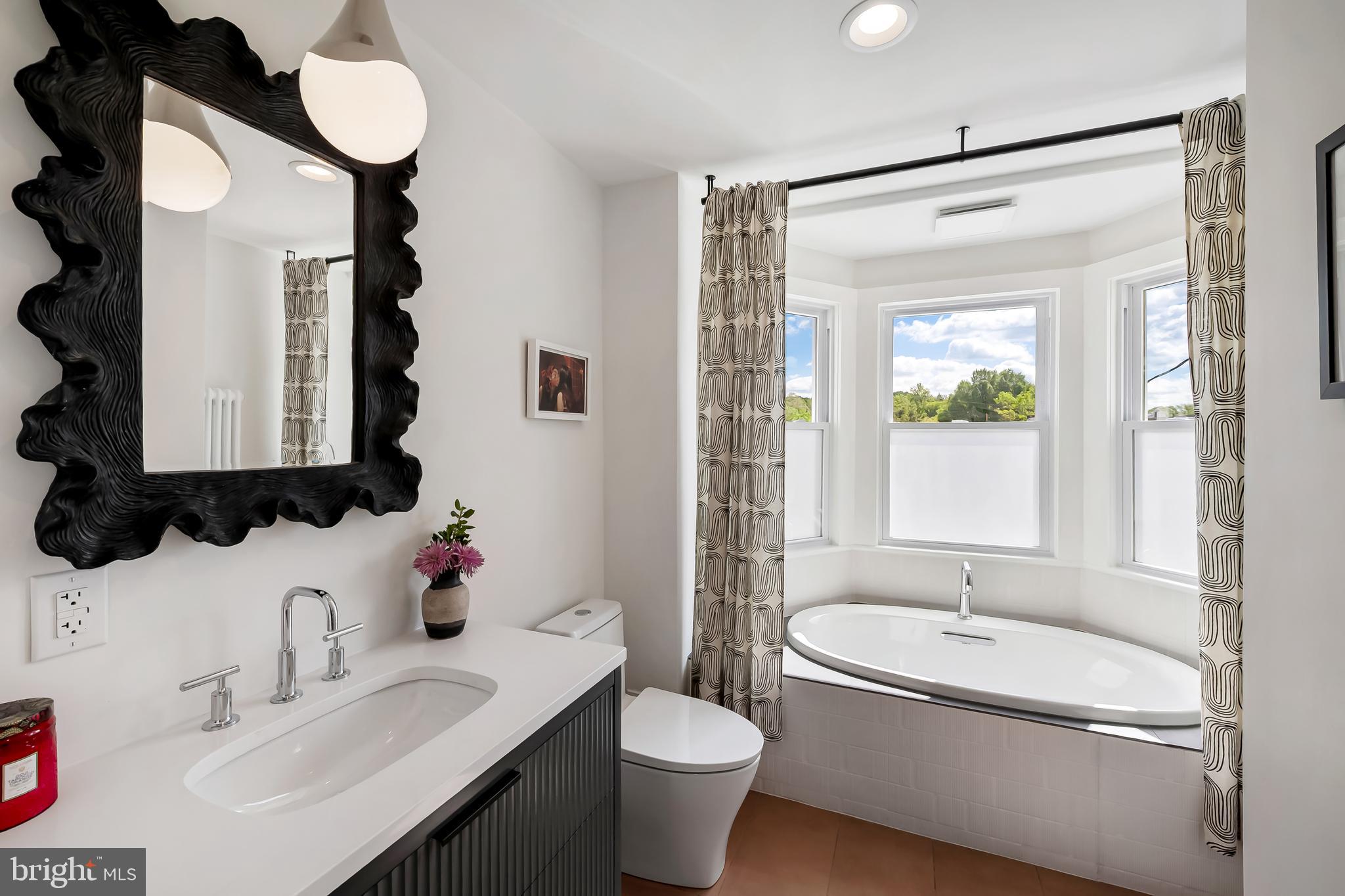 3409 Keswick Road Baltimore, MD 21211 - Photo 28 of 49 a bathroom with a sink toilet and shower