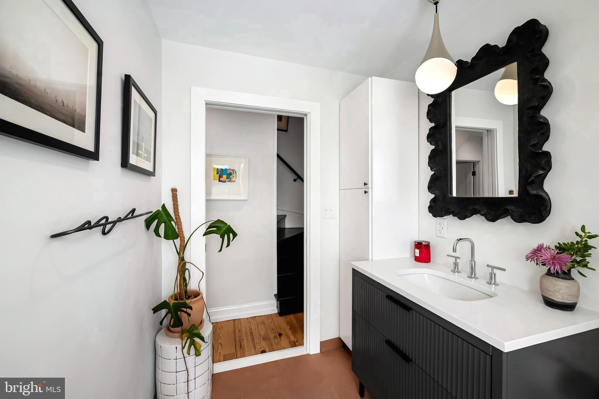 3409 Keswick Road Baltimore, MD 21211 - Photo 30 of 49 a bathroom with a sink vanity and mirror