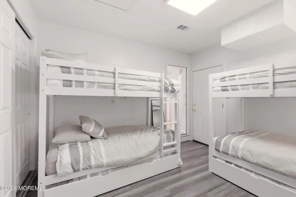 a bedroom with a bed and cabinet