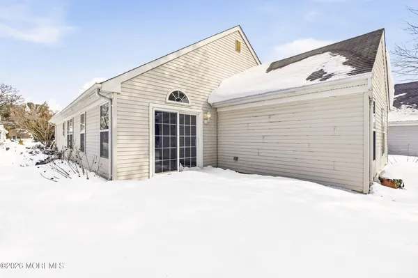 a view of a house with a snow in the yard