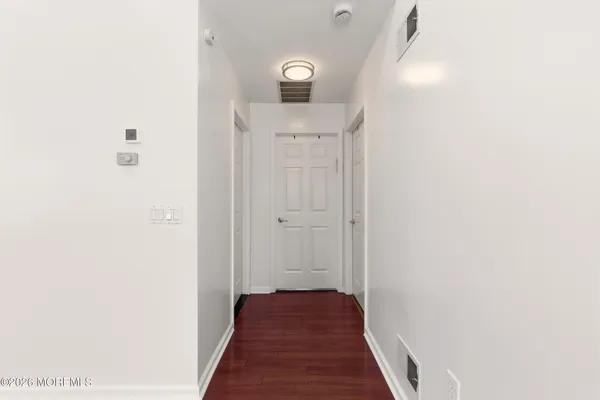 a view of a hallway with wooden floor