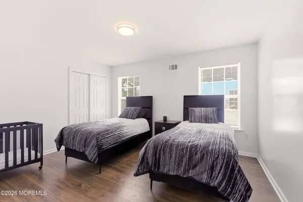 a bedroom with two beds and a window