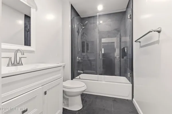 a bathroom with a shower a toilet and a sink