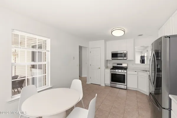 a kitchen with stainless steel appliances a refrigerator and a stove top oven